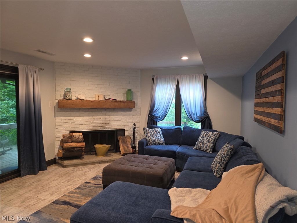2868 Shade Road Akron, OH 44333 - Photo 27 of 49 Living area featuring a white-painted brick fireplace with a substantial wood mantel