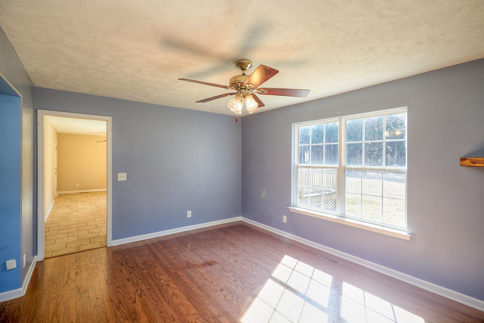 7042 Murfreesboro Road Lebanon, TN 37090 - Photo 12 of 43 an empty room with windows and chandelier fan