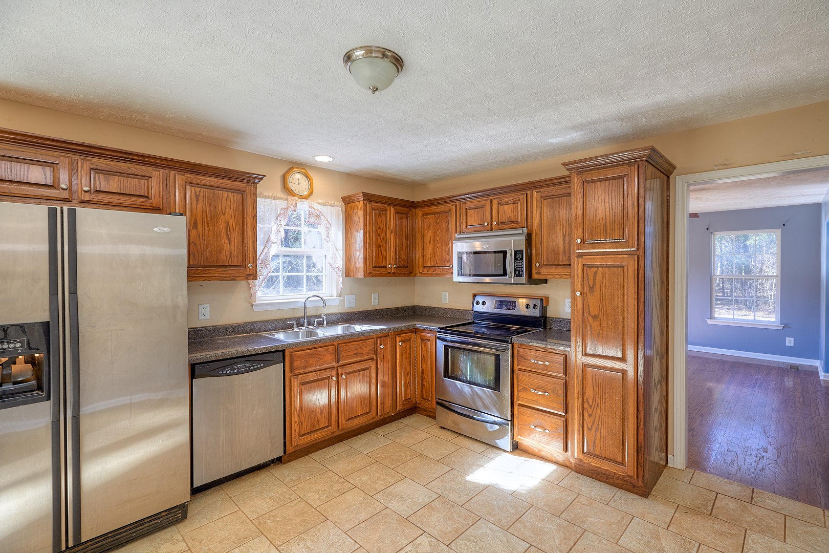 7042 Murfreesboro Road Lebanon, TN 37090 - Photo 17 of 43 a kitchen with stainless steel appliances granite countertop a refrigerator and a sink