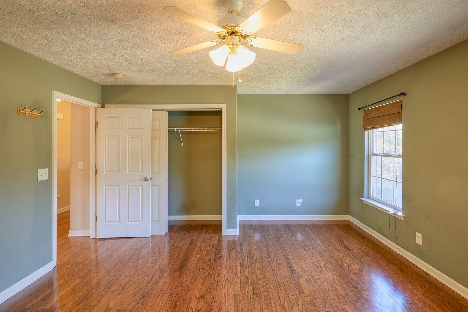7042 Murfreesboro Road Lebanon, TN 37090 - Photo 26 of 43 a view of an empty room with window and wooden floor
