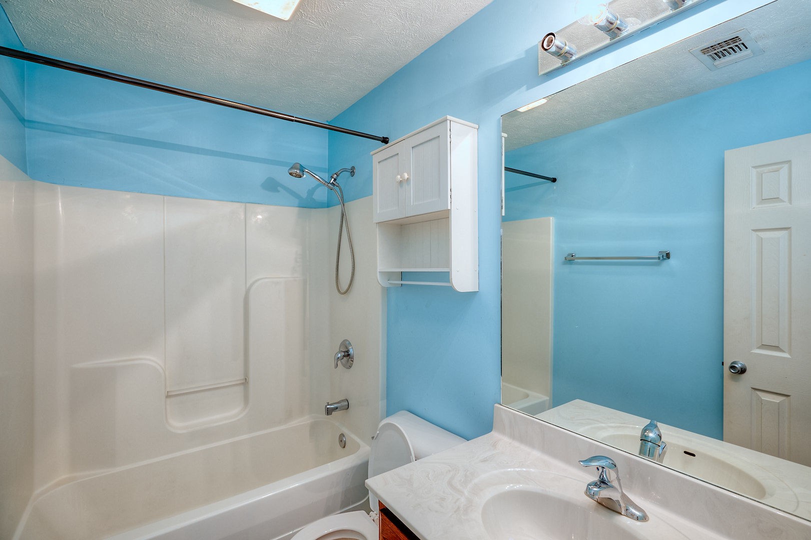 7042 Murfreesboro Road Lebanon, TN 37090 - Photo 31 of 43 a bathroom with a tub shower sink and vanity