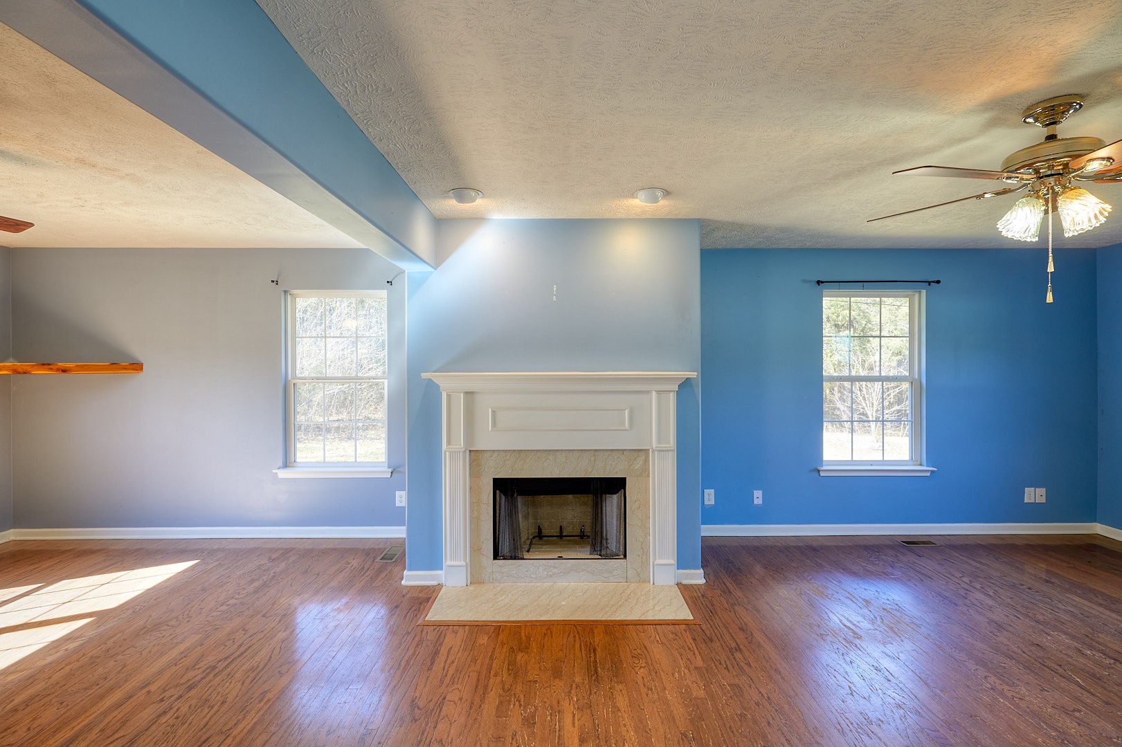 7042 Murfreesboro Road Lebanon, TN 37090 - Photo 10 of 43 a view of an empty room with wooden floor fireplace and a window