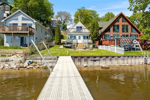 a front view of a house with swimming pool and porch