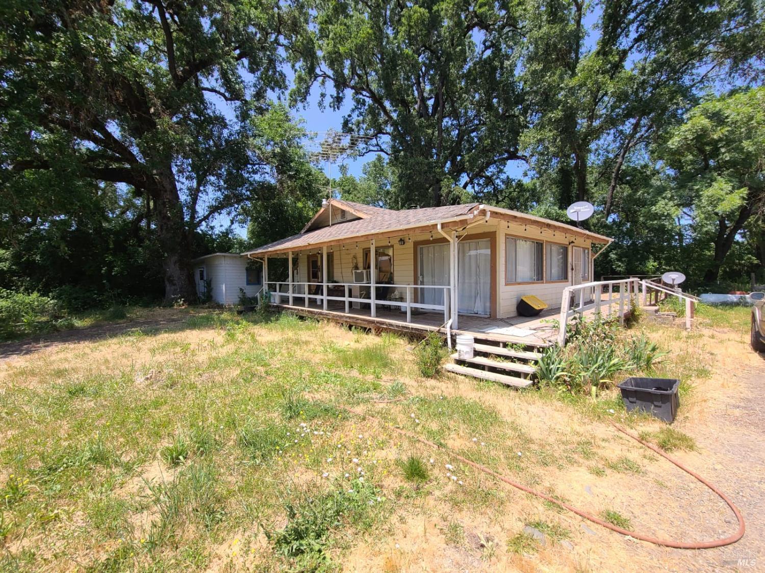 24450 Wattenburg Road Covelo, CA 95428 - Photo 2 of 11 a front view of a house with swimming pool