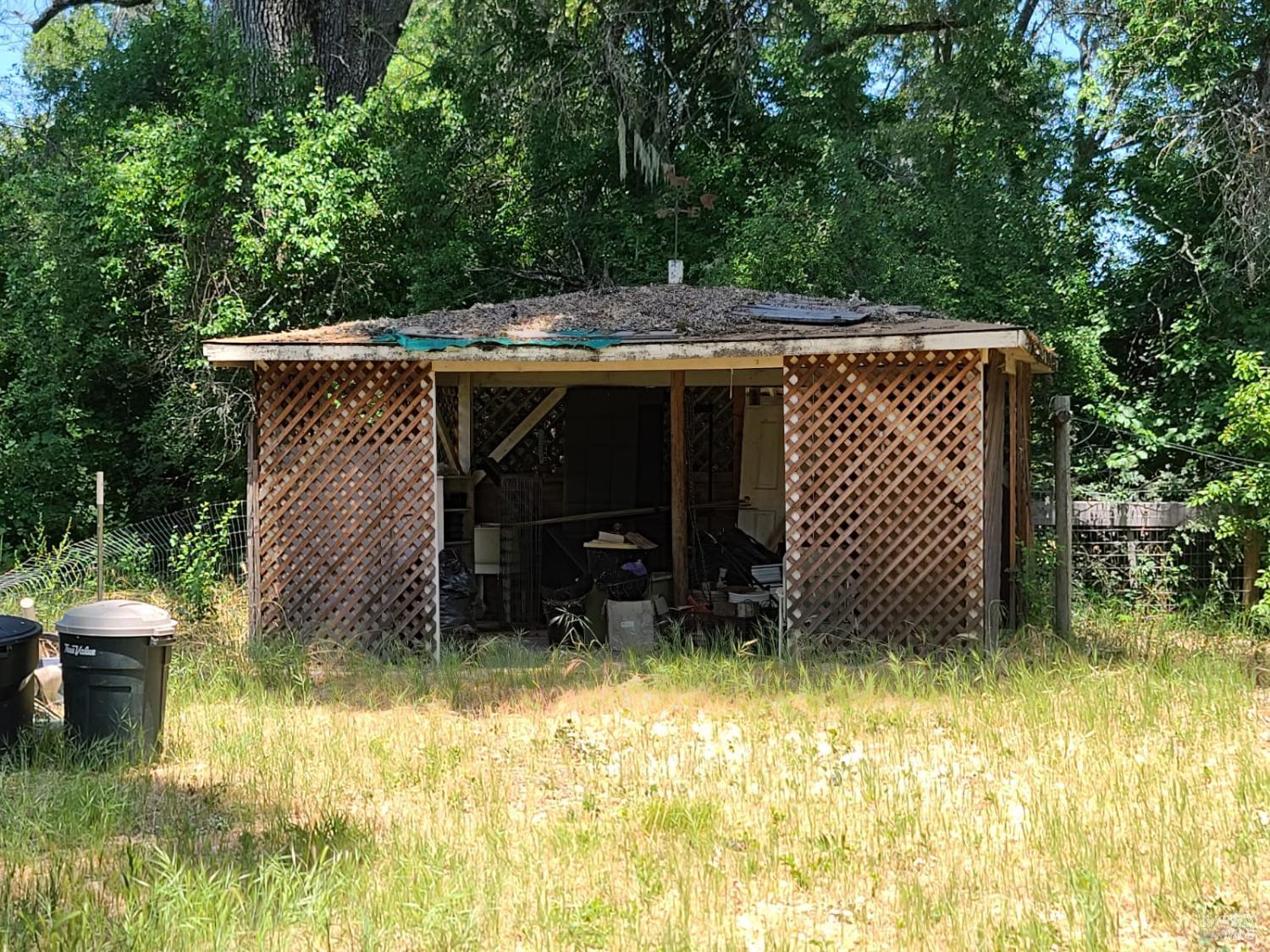24450 Wattenburg Road Covelo, CA 95428 - Photo 7 of 11 a backyard of a house with table and chairs