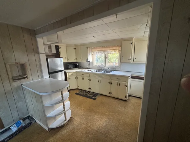 a kitchen with stainless steel appliances granite countertop a refrigerator and a stove