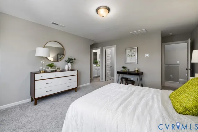 a bedroom with a bed and a dresser