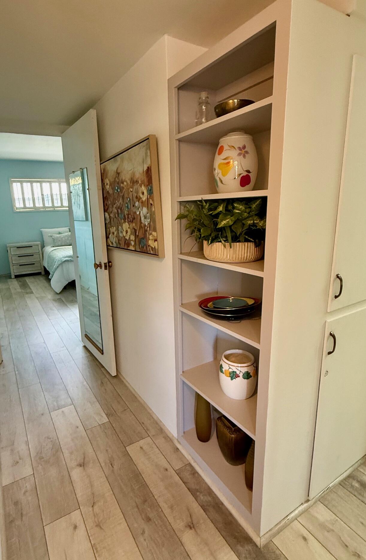69850 Hwy 111 Rancho Mirage Ca, Unit 13 Rancho Mirage, CA 92270 - Photo 13 of 52 Hallway with book shelves & linen closet