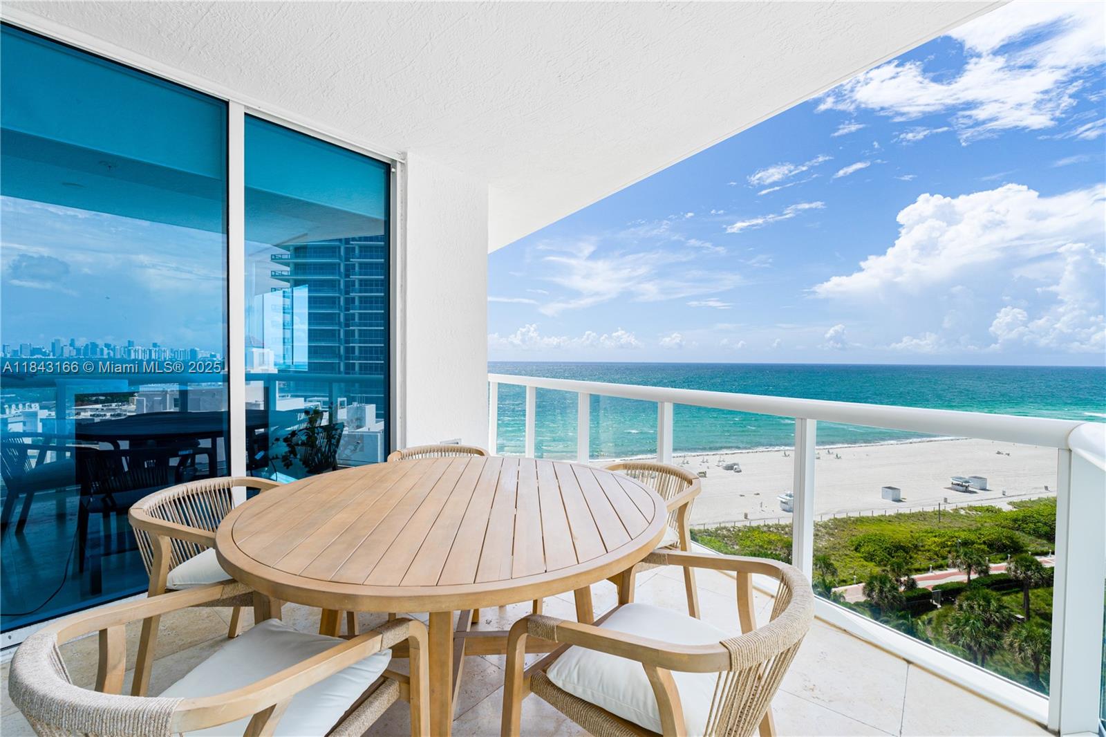 3801 Collins Avenue, Unit 1105 Miami Beach, FL 33140 - Photo 11 of 45 a balcony with table and chairs