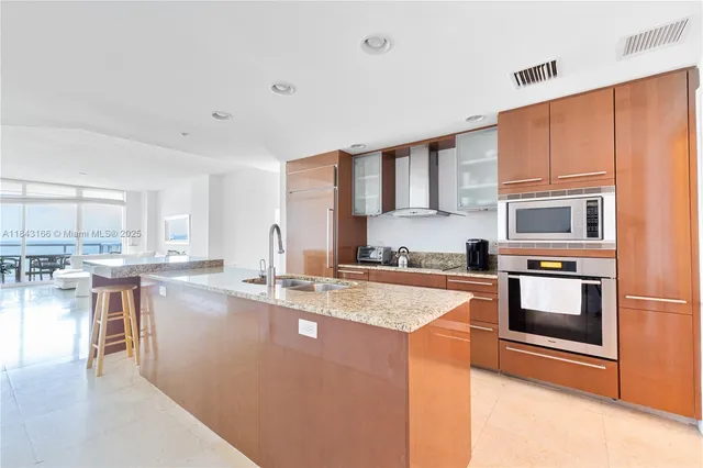a kitchen with granite countertop a sink and a counter top space