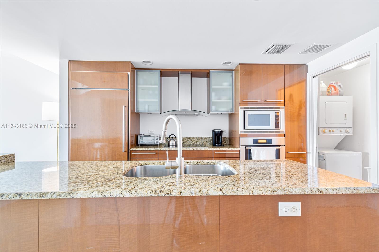 3801 Collins Avenue, Unit 1105 Miami Beach, FL 33140 - Photo 19 of 45 a kitchen with granite countertop a sink and a counter top space