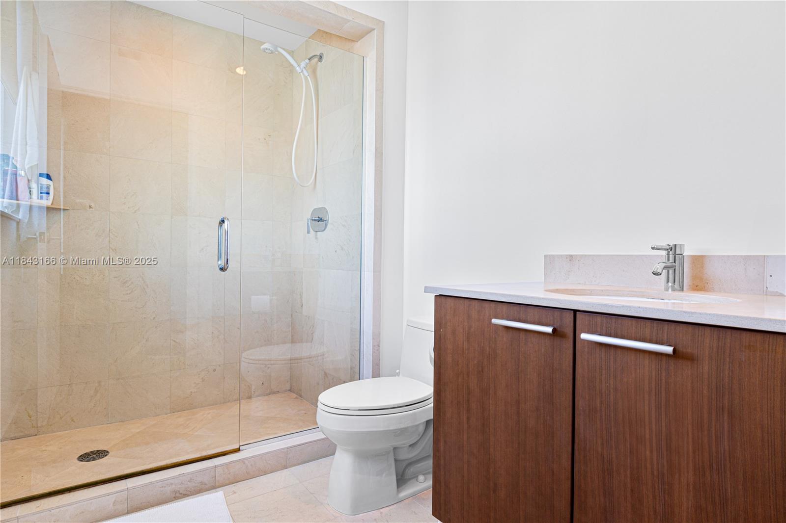 3801 Collins Avenue, Unit 1105 Miami Beach, FL 33140 - Photo 23 of 45 a bathroom with a shower a toilet and sink