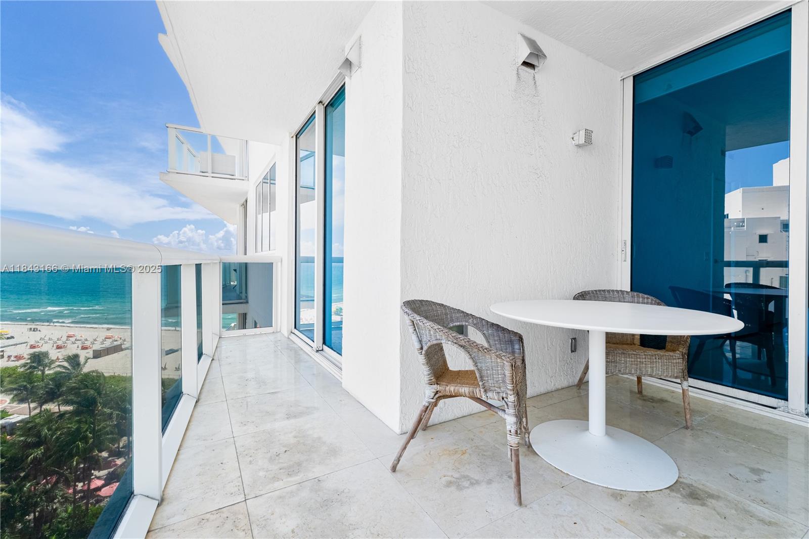 3801 Collins Avenue, Unit 1105 Miami Beach, FL 33140 - Photo 26 of 45 a balcony with table and chairs