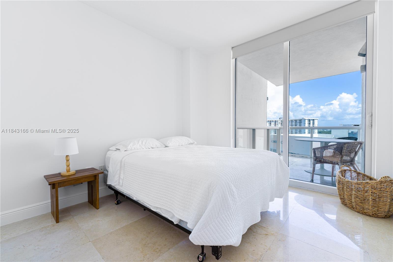 3801 Collins Avenue, Unit 1105 Miami Beach, FL 33140 - Photo 29 of 45 a bed room with a bed and a table