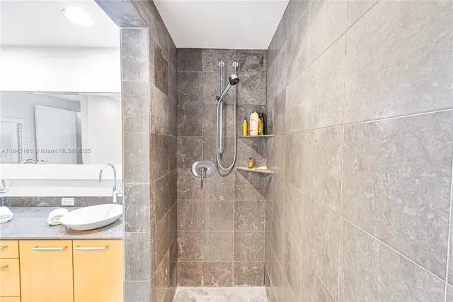 a white toilet sitting next to a white sink