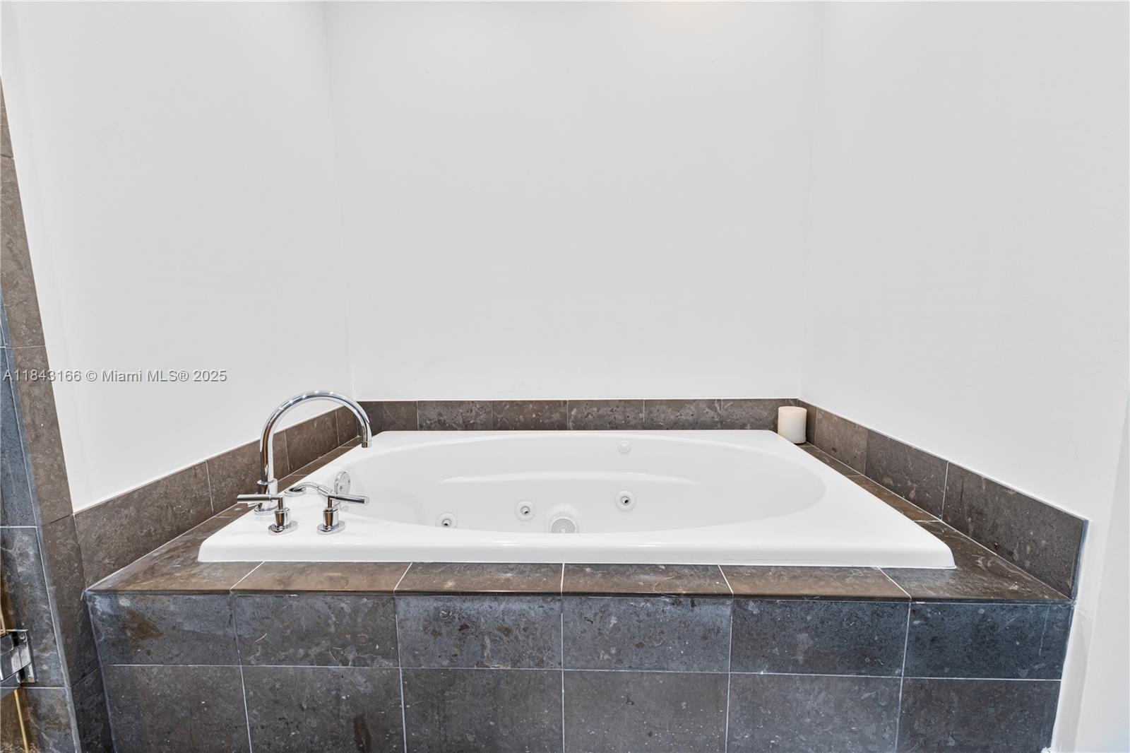 3801 Collins Avenue, Unit 1105 Miami Beach, FL 33140 - Photo 35 of 45 a bathroom with a bathtub