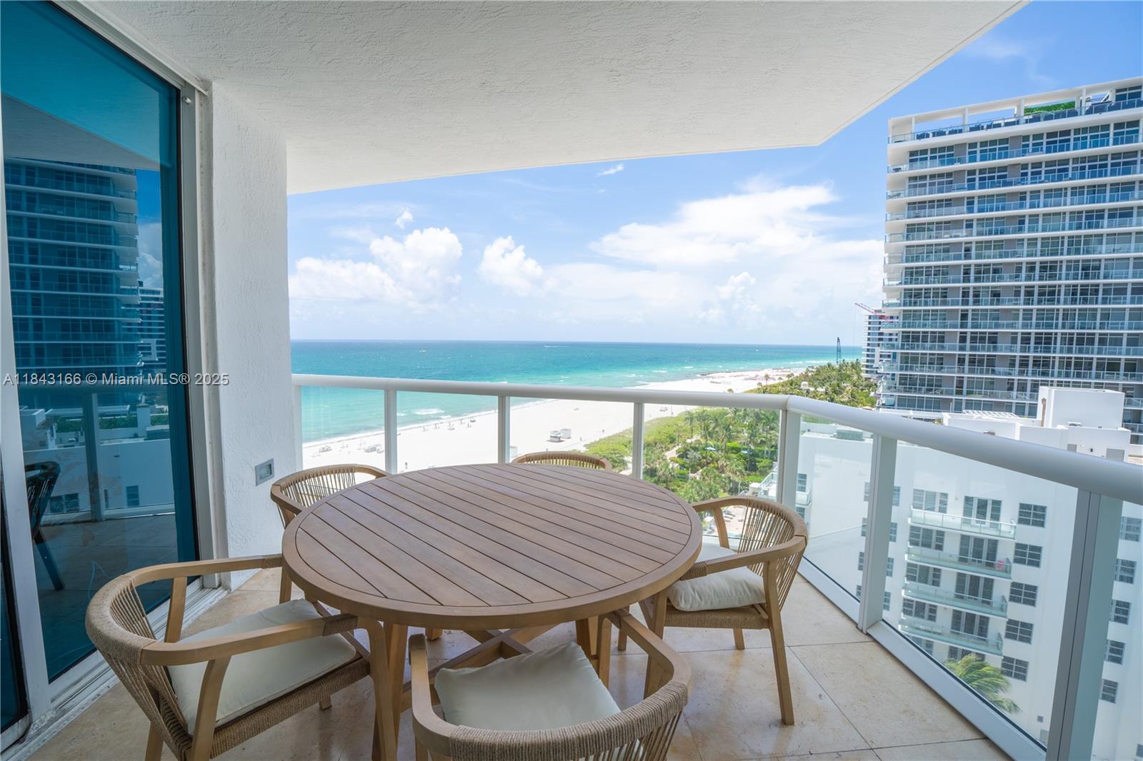 3801 Collins Avenue, Unit 1105 Miami Beach, FL 33140 - Photo 37 of 45 a view of a balcony with table and chairs