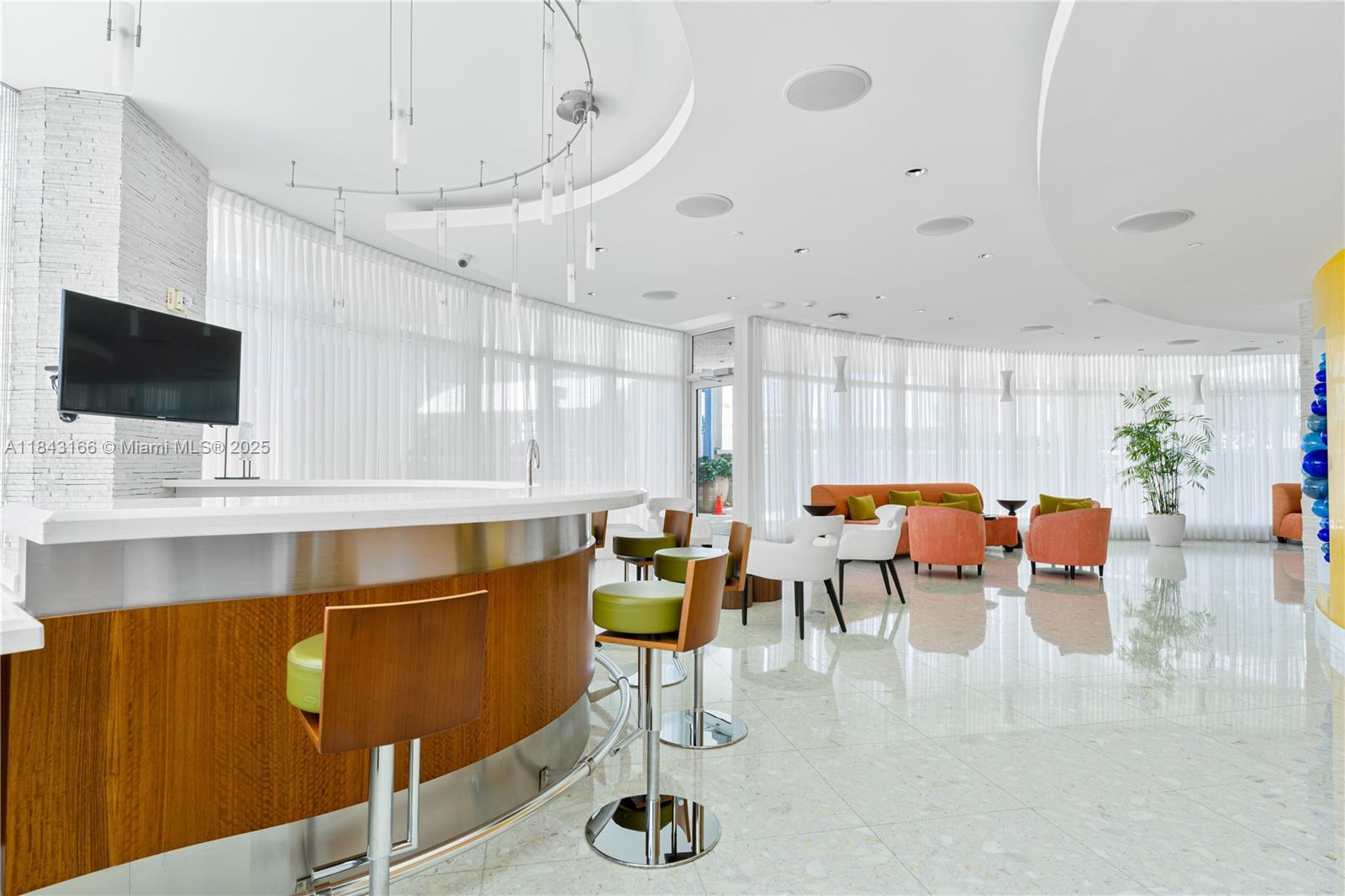 3801 Collins Avenue, Unit 1105 Miami Beach, FL 33140 - Photo 41 of 45 a living room with lots of furniture and a flat screen tv