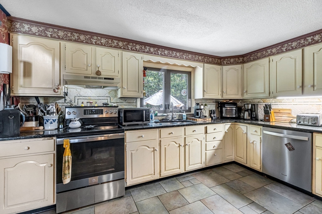 163 South Monson Road Hampden, MA 01036 - Photo 7 of 34 a kitchen with stainless steel appliances granite countertop white cabinets granite counter tops and a window