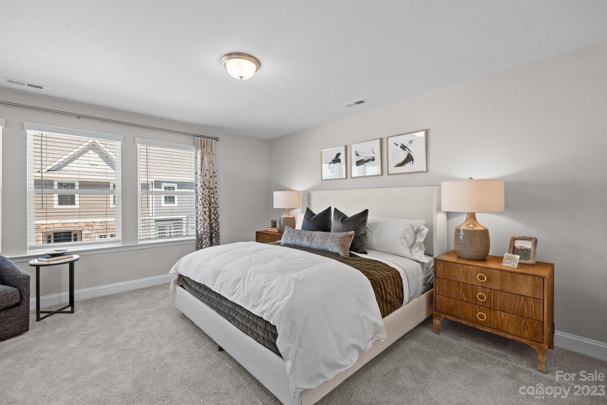 1037 South Point Road, Unit 12 Belmont, NC 28012 - Photo 13 of 17 a spacious bedroom with a bed and a large window