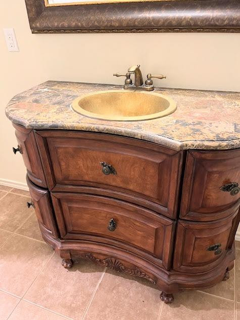 3913 100th Street Lubbock, TX 79423 - Photo 20 of 35 a bathroom with a granite countertop sink and a mirror