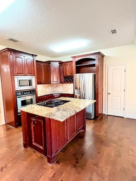 3913 100th Street Lubbock, TX 79423 - Photo 7 of 35 a kitchen with a stove and a refrigerator