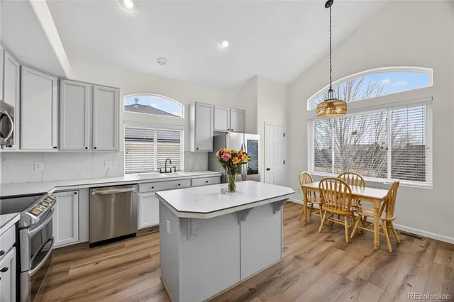 a kitchen with a sink a counter top space and appliances