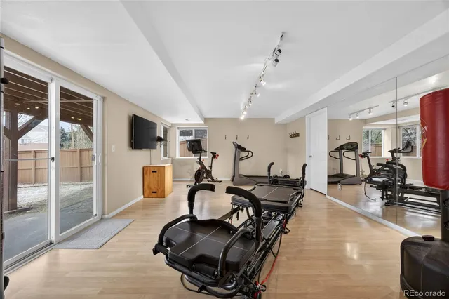 a room with gym equipment and a flat screen tv