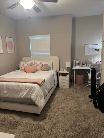 a bedroom with a bed and a desk