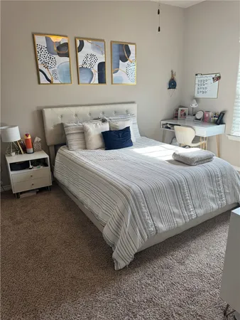 a bedroom with a bed and lamp