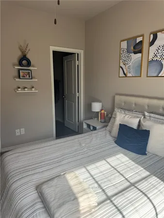 a bedroom with a large bed and a couch