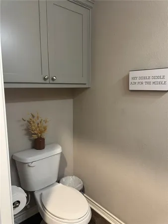 a white toilet sitting next to a sink