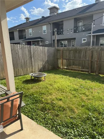 a backyard of a house with a yard and stairs