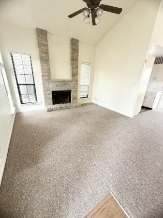 a view of an empty room with a fireplace
