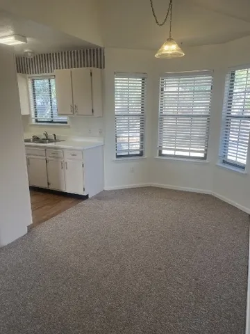 a view of room with window and cabinet
