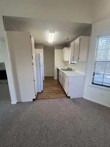 a view of a kitchen with a sink cabinets and a window