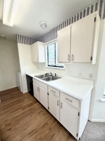 a spacious bathroom with a sink and a mirror