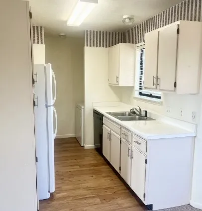 a kitchen with a sink a refrigerator and a stove