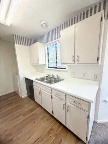 a view of a kitchen with sink and cabinets