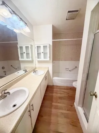 a bathroom with a tub sink and mirror