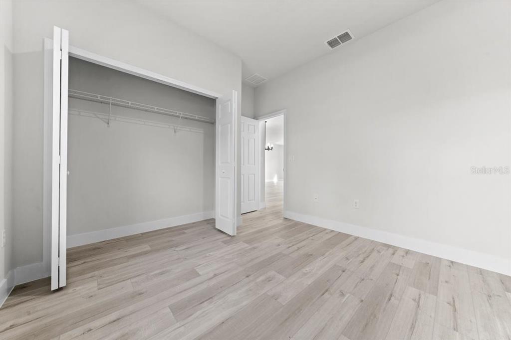 15495 Southwest 49th Avenue Road Ocala, FL 34473 - Photo 25 of 65 a view of an empty room with wooden floor and closet