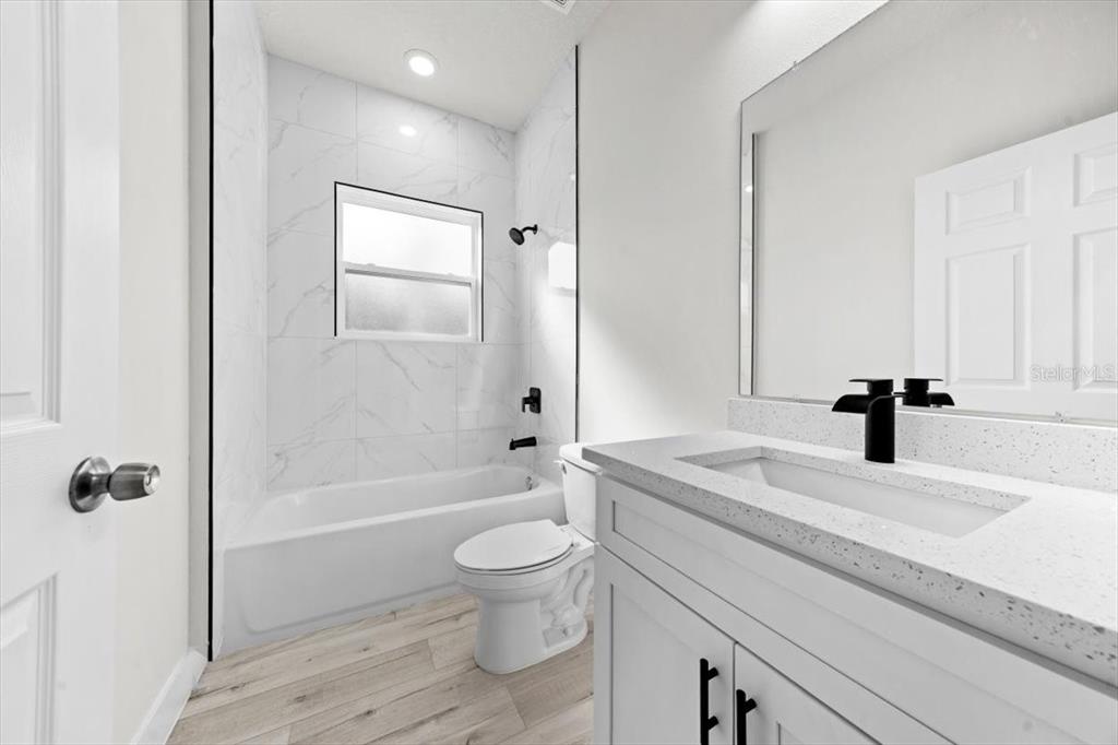 15495 Southwest 49th Avenue Road Ocala, FL 34473 - Photo 27 of 65 a bathroom with a granite countertop sink a toilet and shower