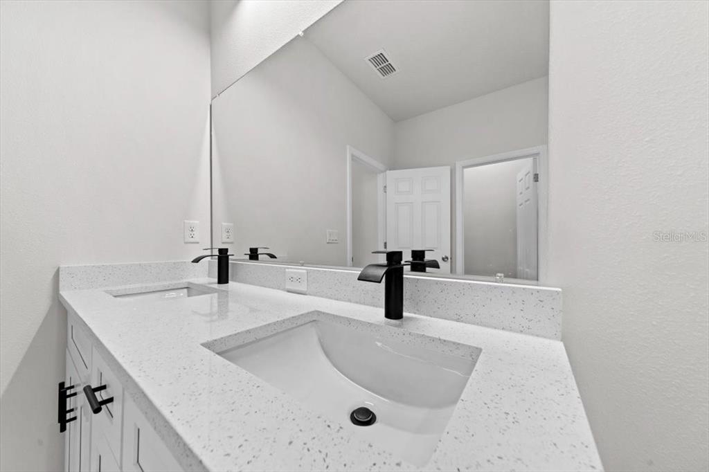 15495 Southwest 49th Avenue Road Ocala, FL 34473 - Photo 28 of 65 a bathroom with a double vanity sink