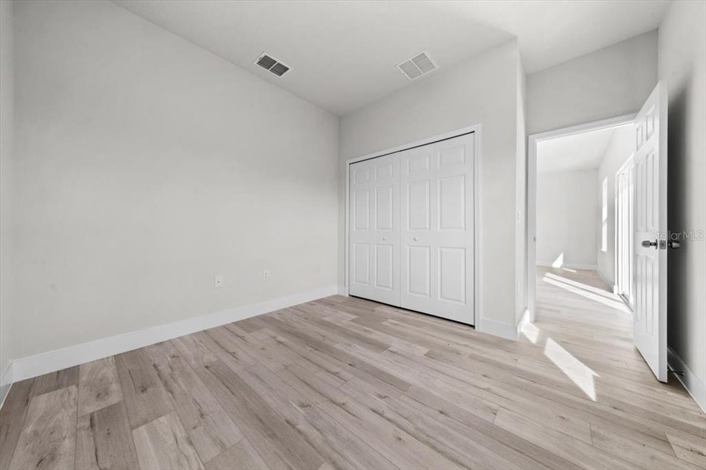 15495 Southwest 49th Avenue Road Ocala, FL 34473 - Photo 30 of 65 a view of an empty room with wooden floor and a window