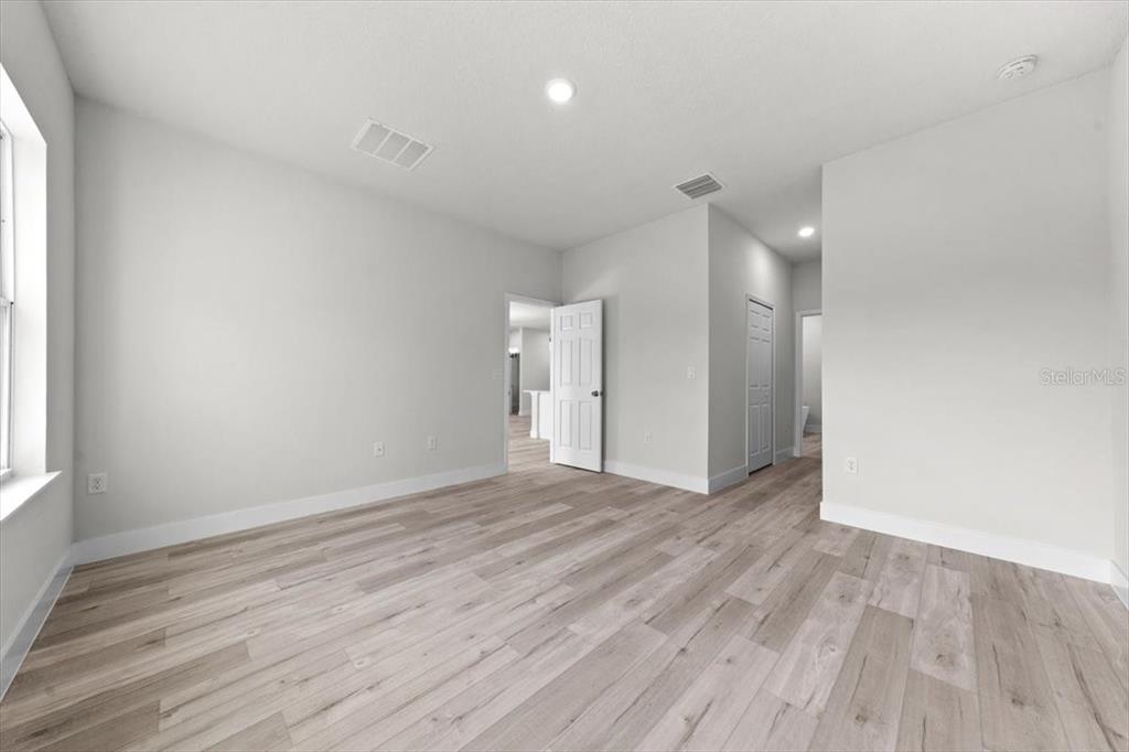 15495 Southwest 49th Avenue Road Ocala, FL 34473 - Photo 31 of 65 a view of an empty room with wooden floor and a window