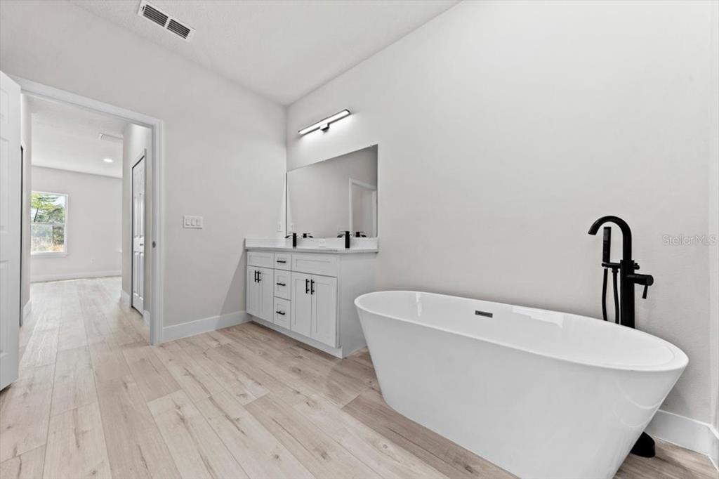 15495 Southwest 49th Avenue Road Ocala, FL 34473 - Photo 43 of 65 a spacious bathroom with a bathtub and shower