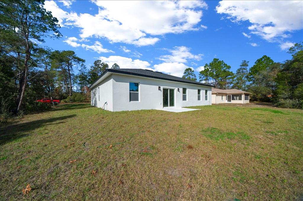 15495 Southwest 49th Avenue Road Ocala, FL 34473 - Photo 50 of 65 a view of a house with backyard and garden