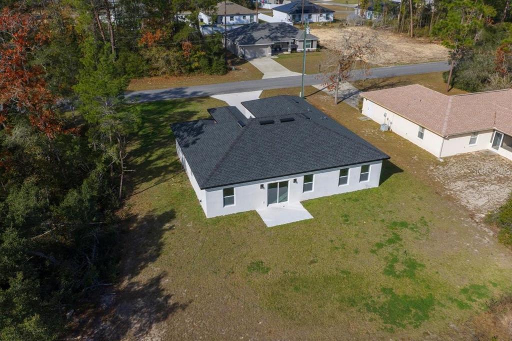 15495 Southwest 49th Avenue Road Ocala, FL 34473 - Photo 61 of 65 an aerial view of residential houses with outdoor space and trees