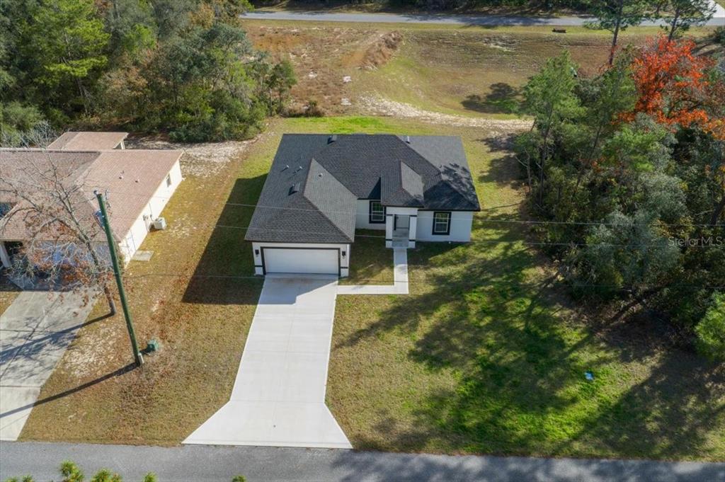 15495 Southwest 49th Avenue Road Ocala, FL 34473 - Photo 64 of 65 an aerial view of a house with a yard basket ball court and outdoor seating