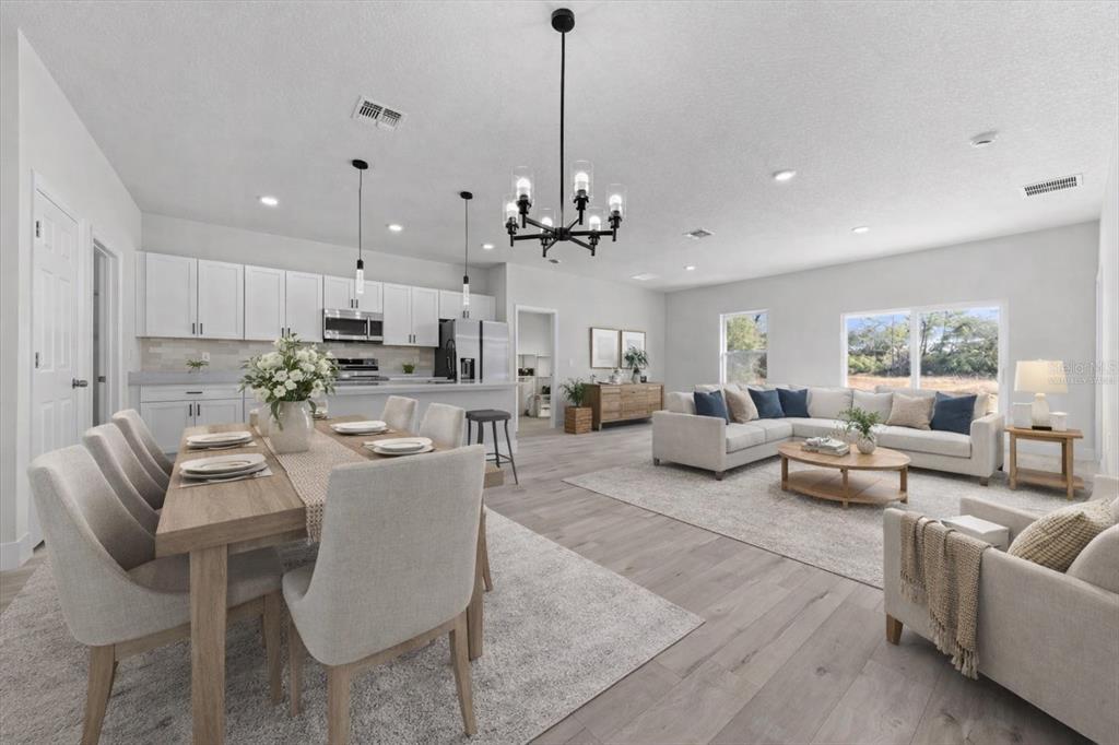 15495 Southwest 49th Avenue Road Ocala, FL 34473 - Photo 9 of 65 a living room with furniture kitchen view and a chandelier